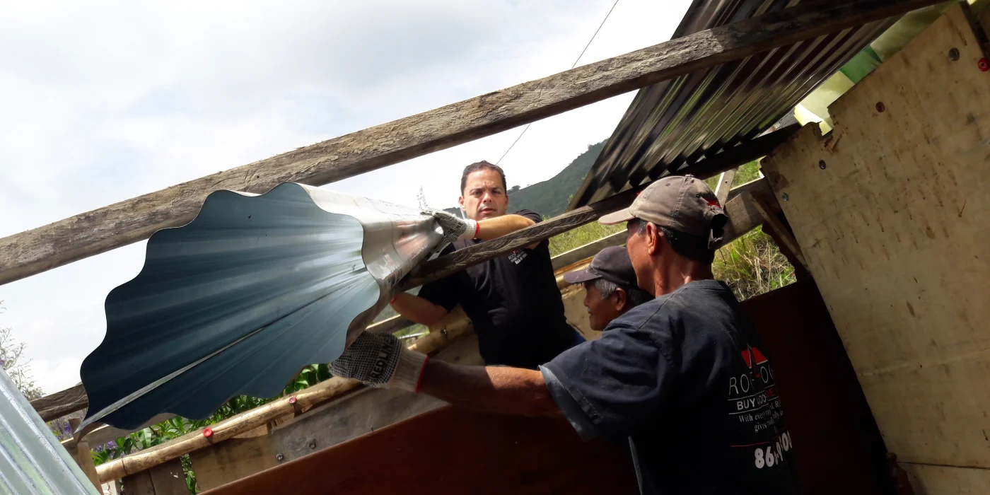 Chuck Anania fixing a roof in South America