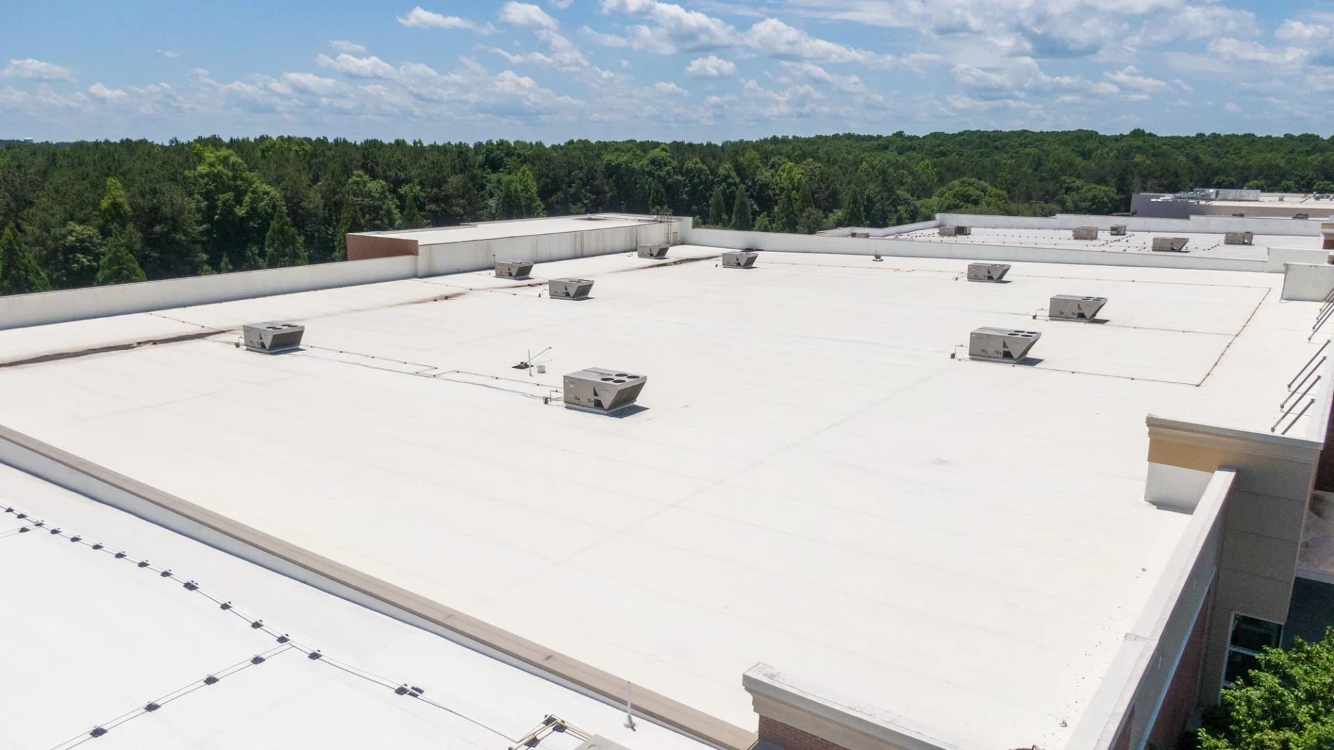 Overhead view of a series of commercial building roofs in a single complex