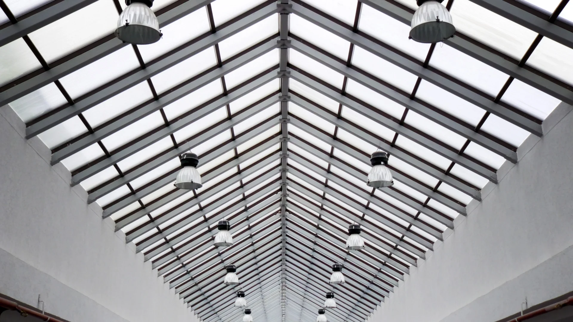 Upward interior view of a long, peaked skylight in a commercial building