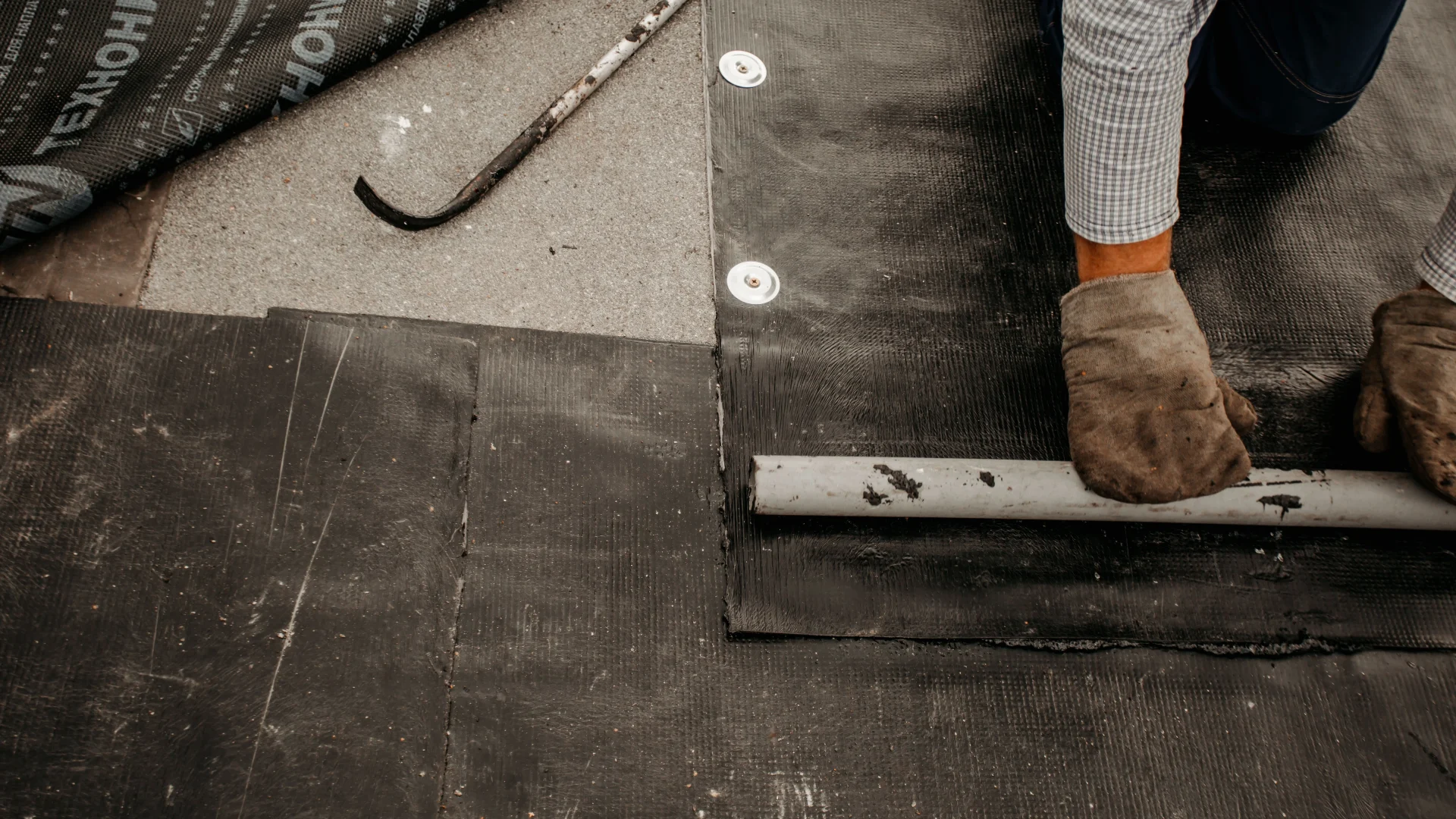 Close view of a contractor repairing a commercial roof