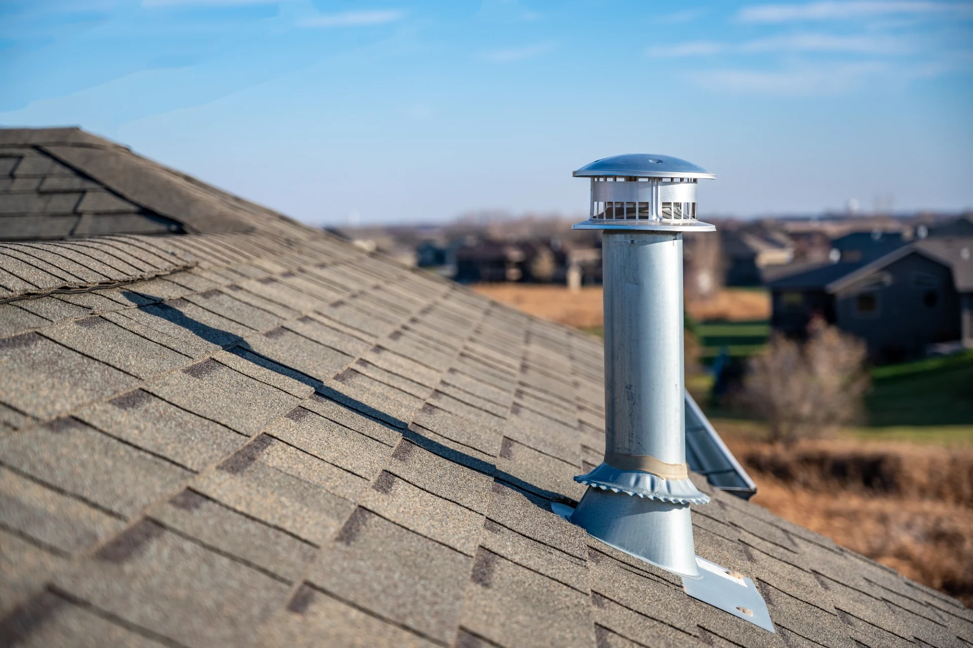 A metal chimney on a roof