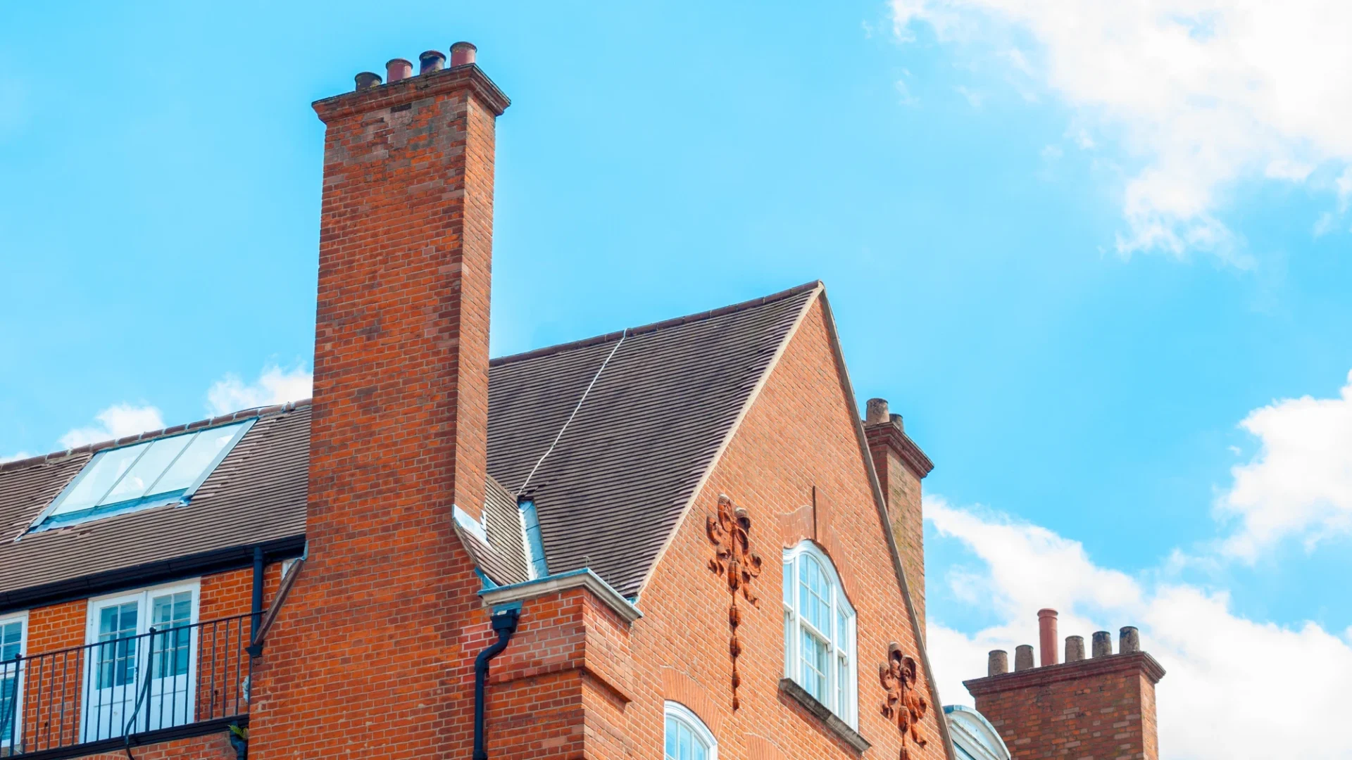 Tall brick chimney on a brick church
