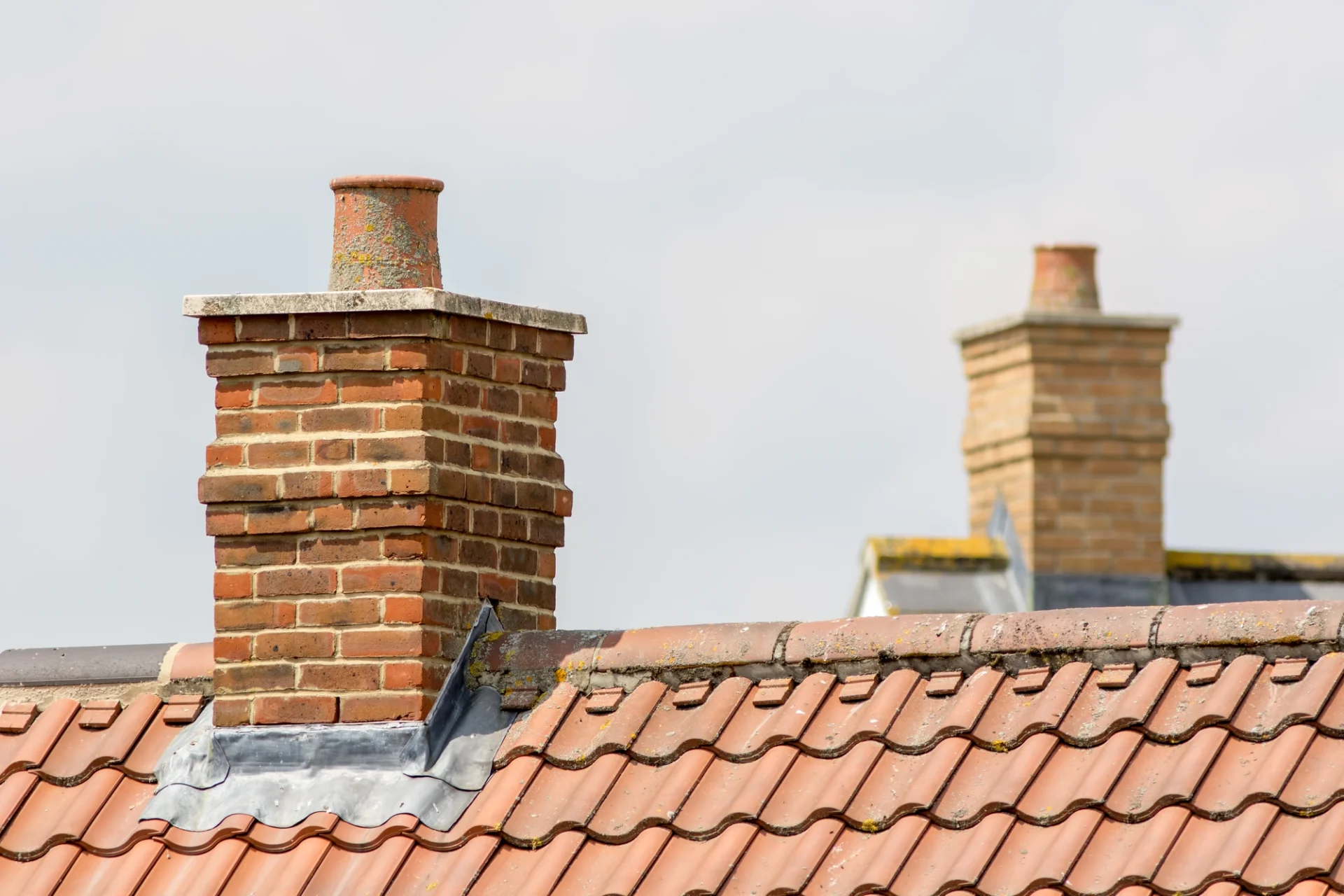 A roof with a brick chimney