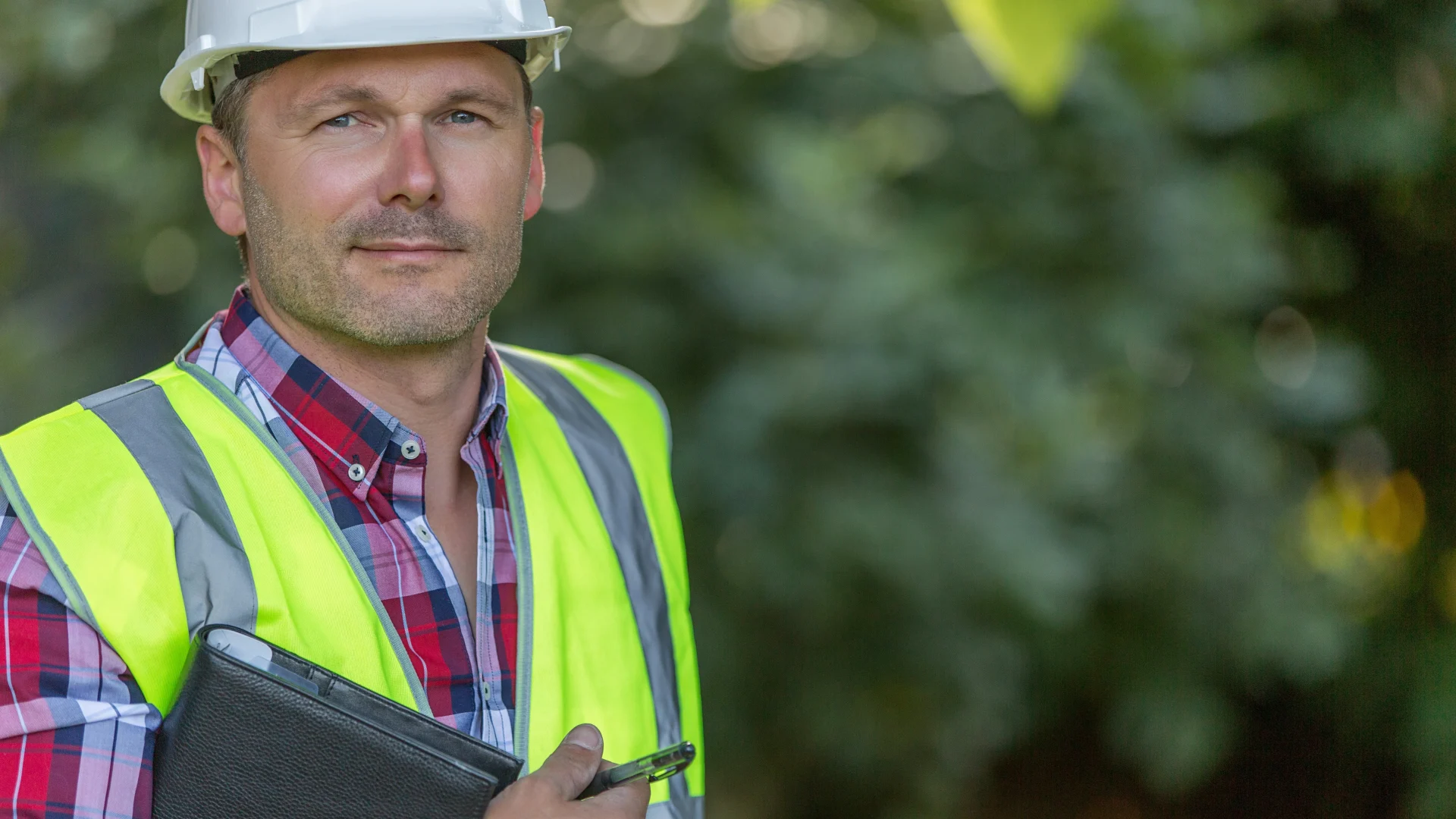 Close head-on view of a roofing contractor holding a clipboard