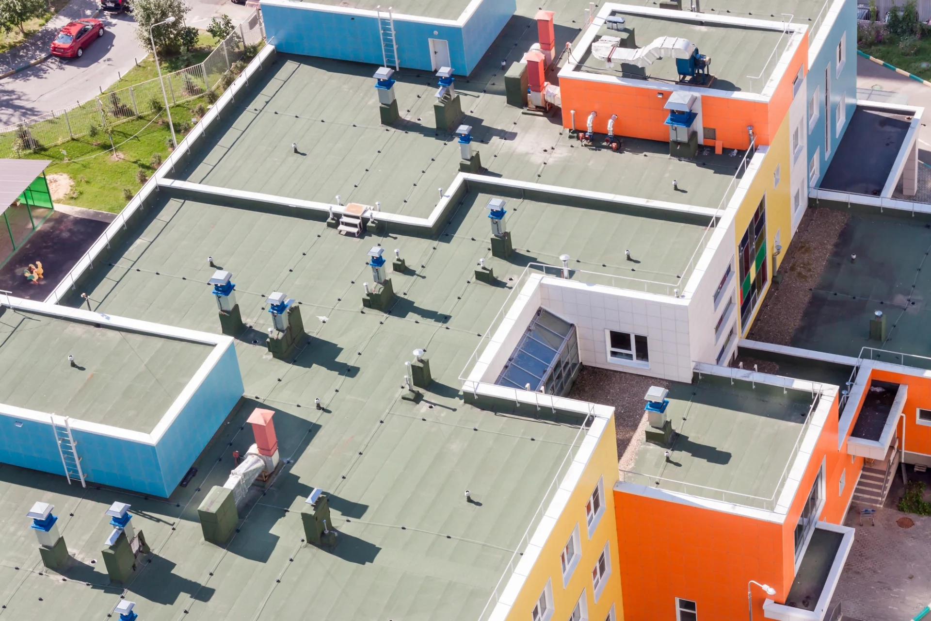 A colorful apartment building with flat roofing