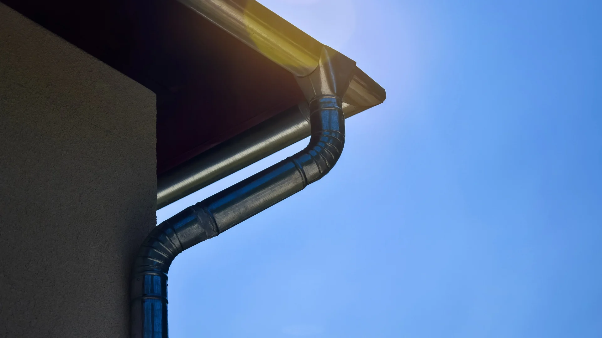 Close view of a large downspout on a commercial building
