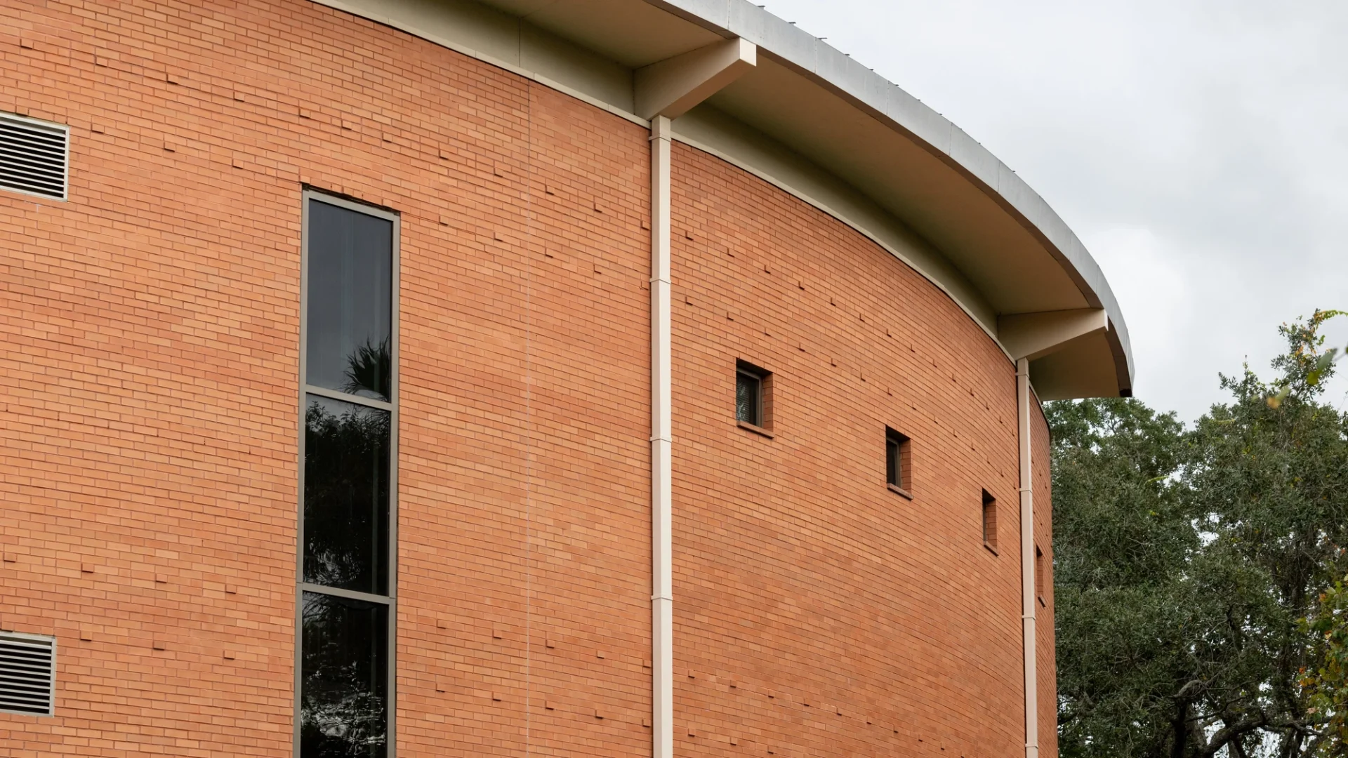 View of the gutter system on a curved commercial brick building