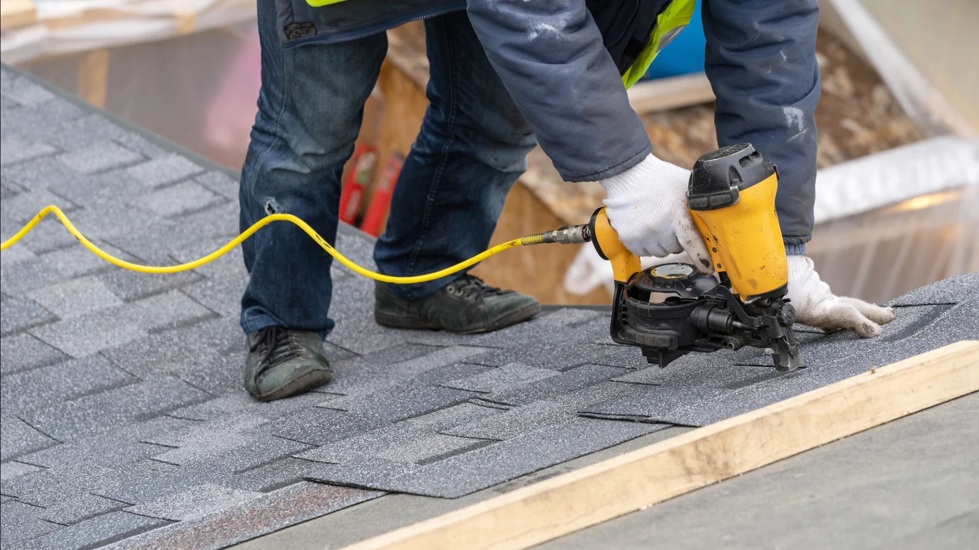Roofing contractor installing shingles
