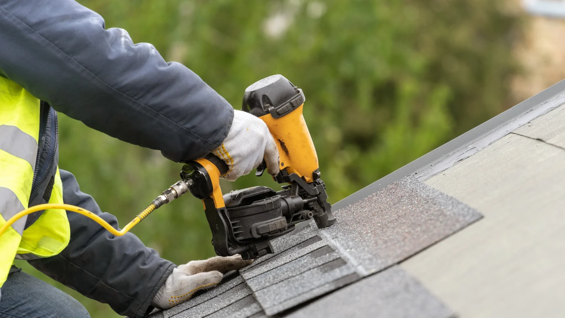 Roofer installing shingles