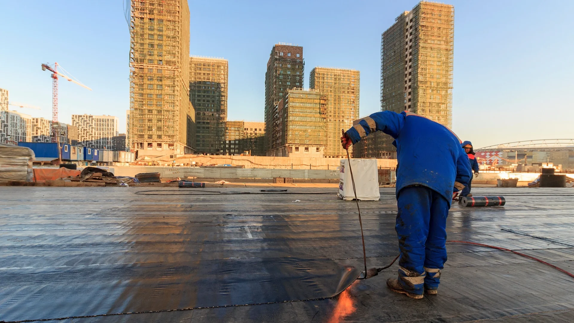 Roofer installing waterproof coating