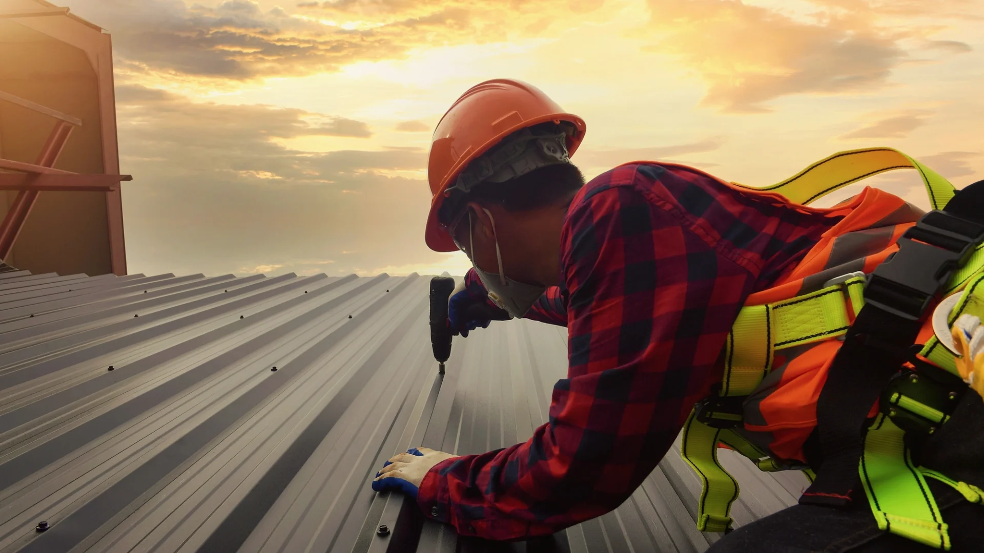 A roofer repairs a commercial metal roof