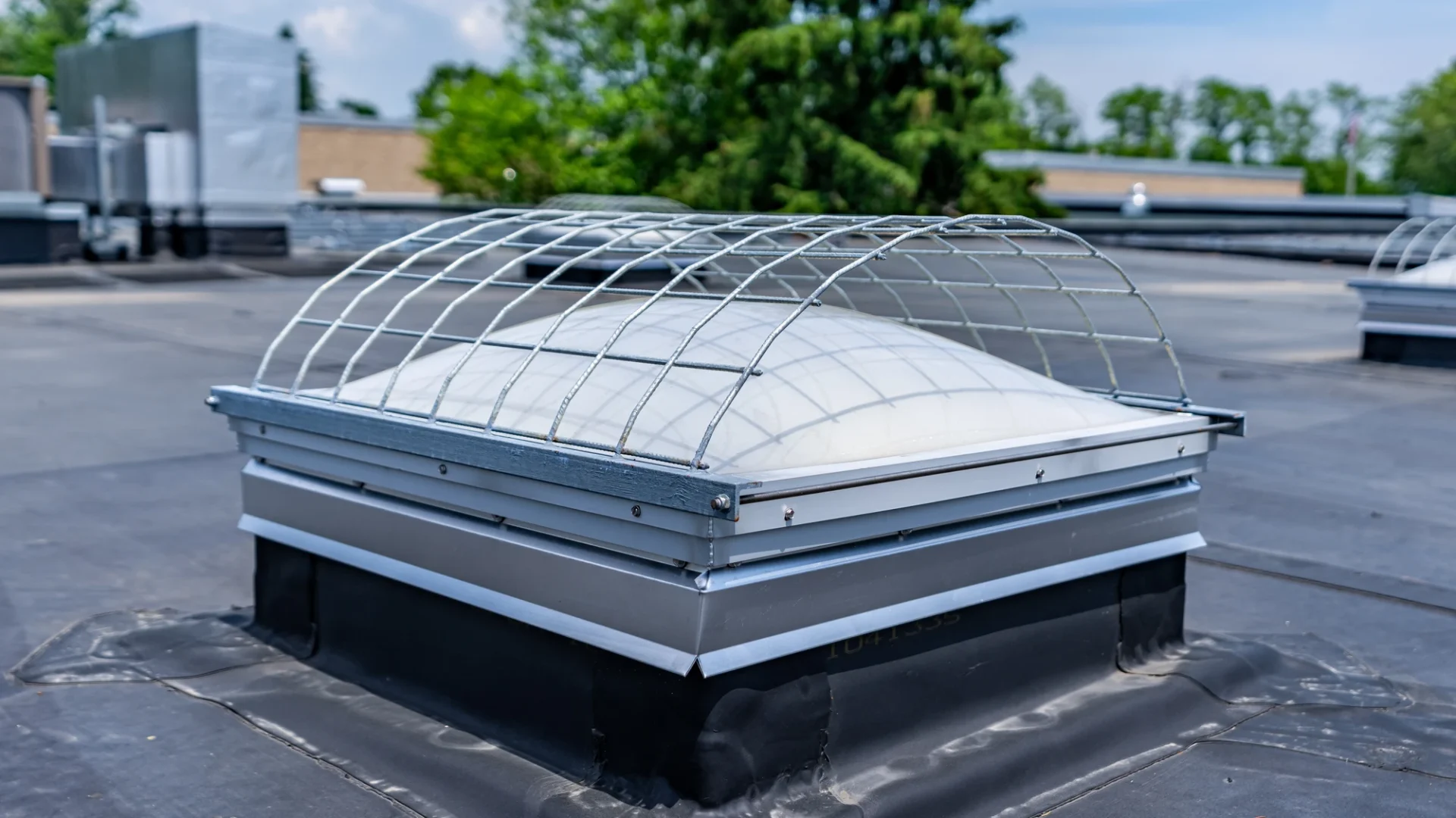 Close view of a skylight with a fall guard on top of a commercial building