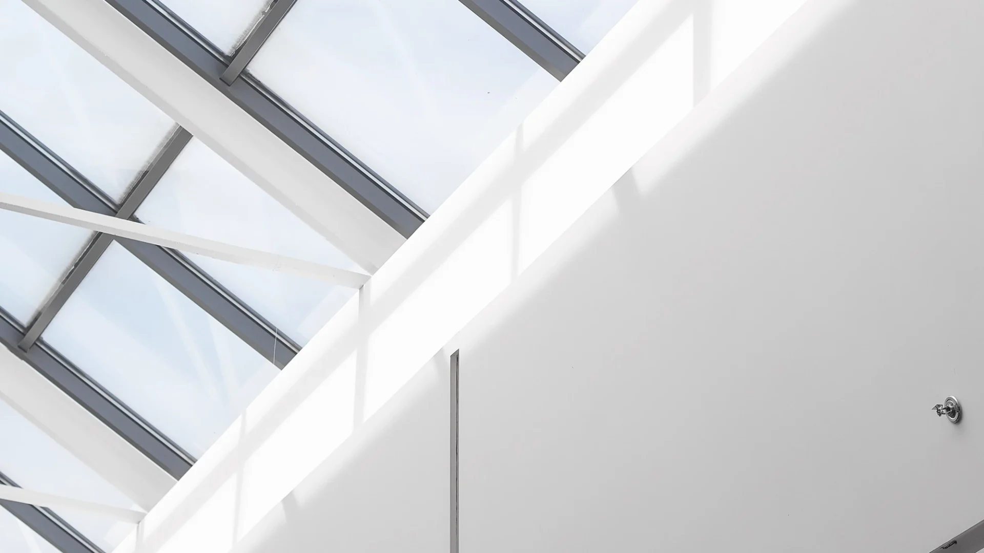 Close view of light pouring through skylights in a commercial building