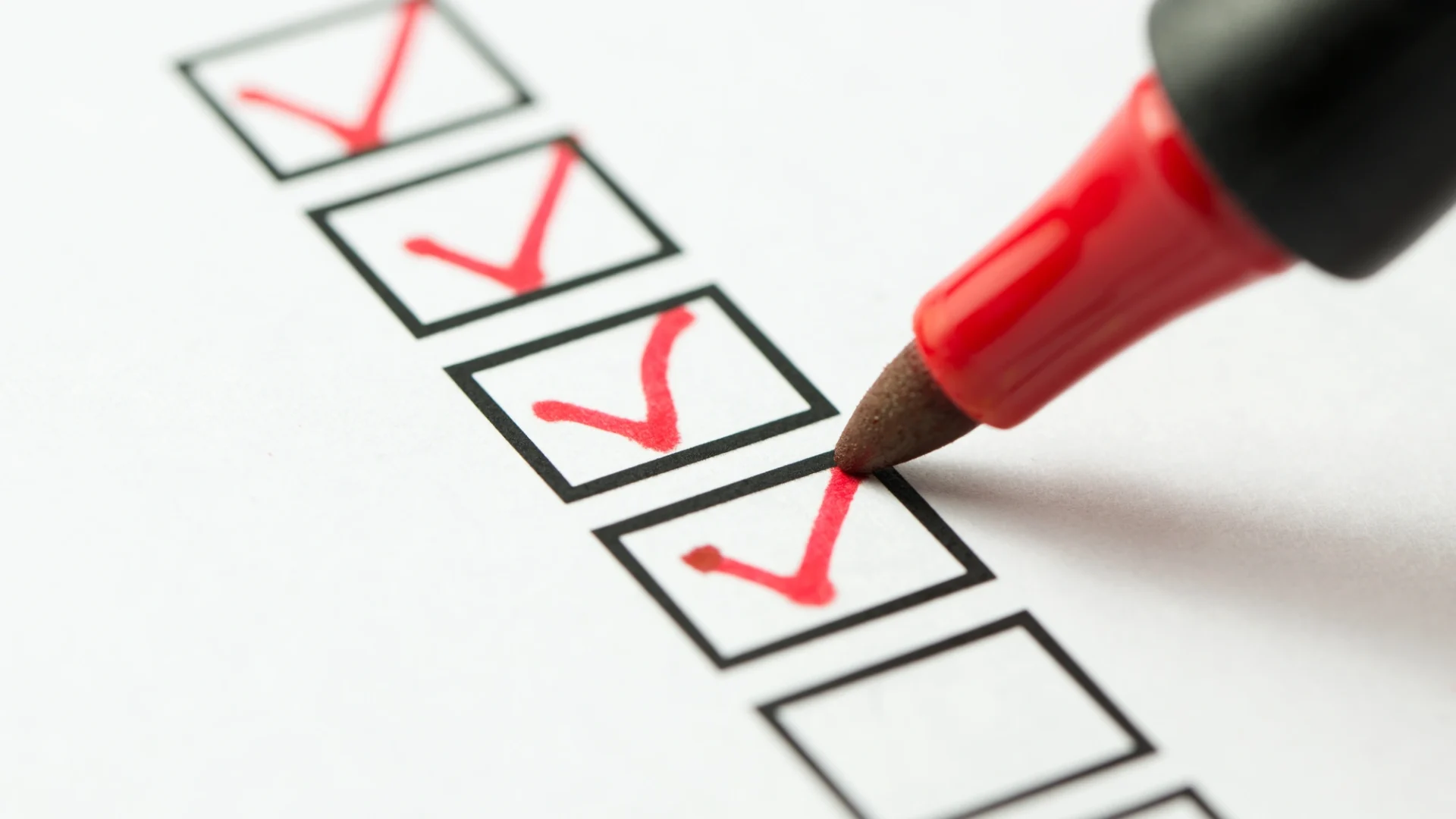 A red marker is used to checkmark empty boxes