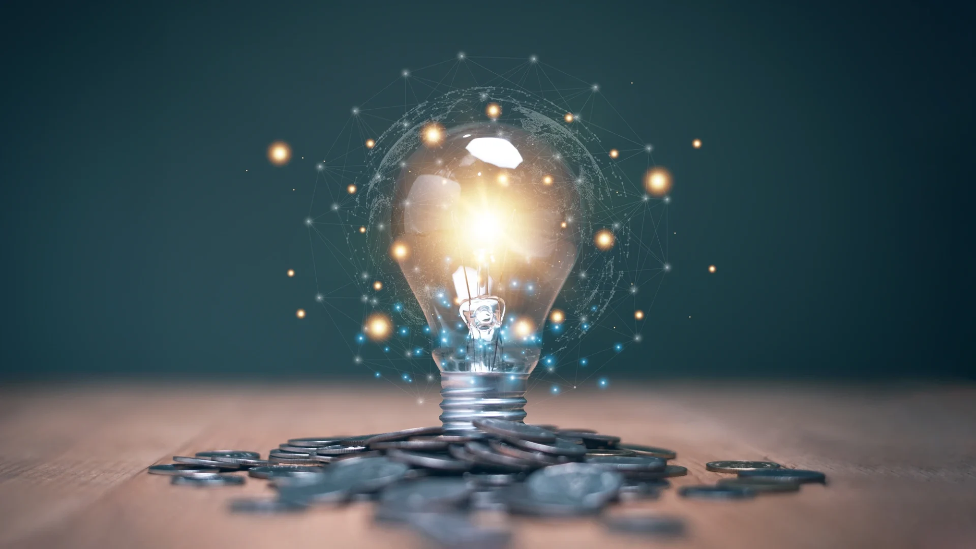 A bright lightbulb hovers over a growing stack of coins