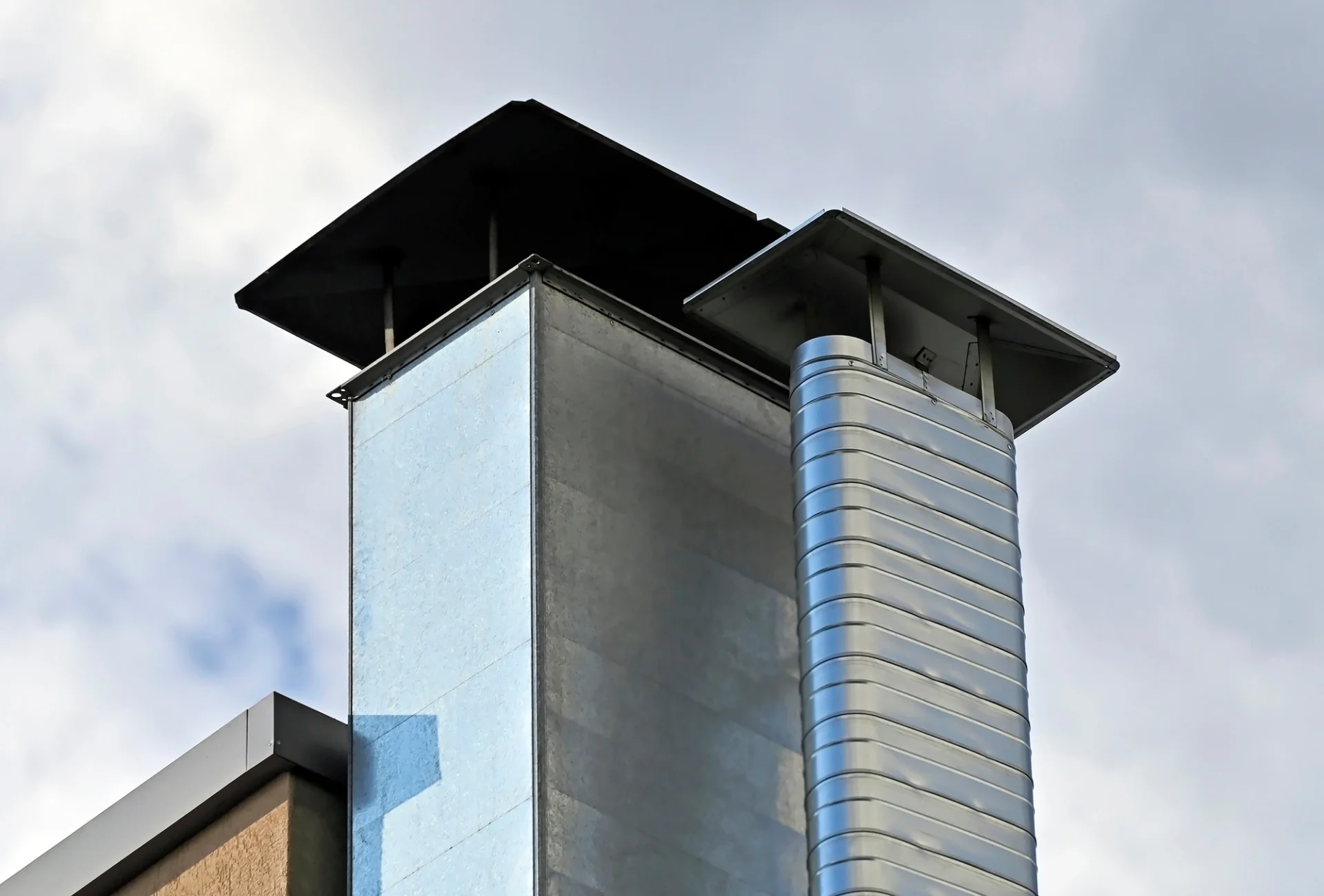 A close-up view of a large chimney on a commercial building
