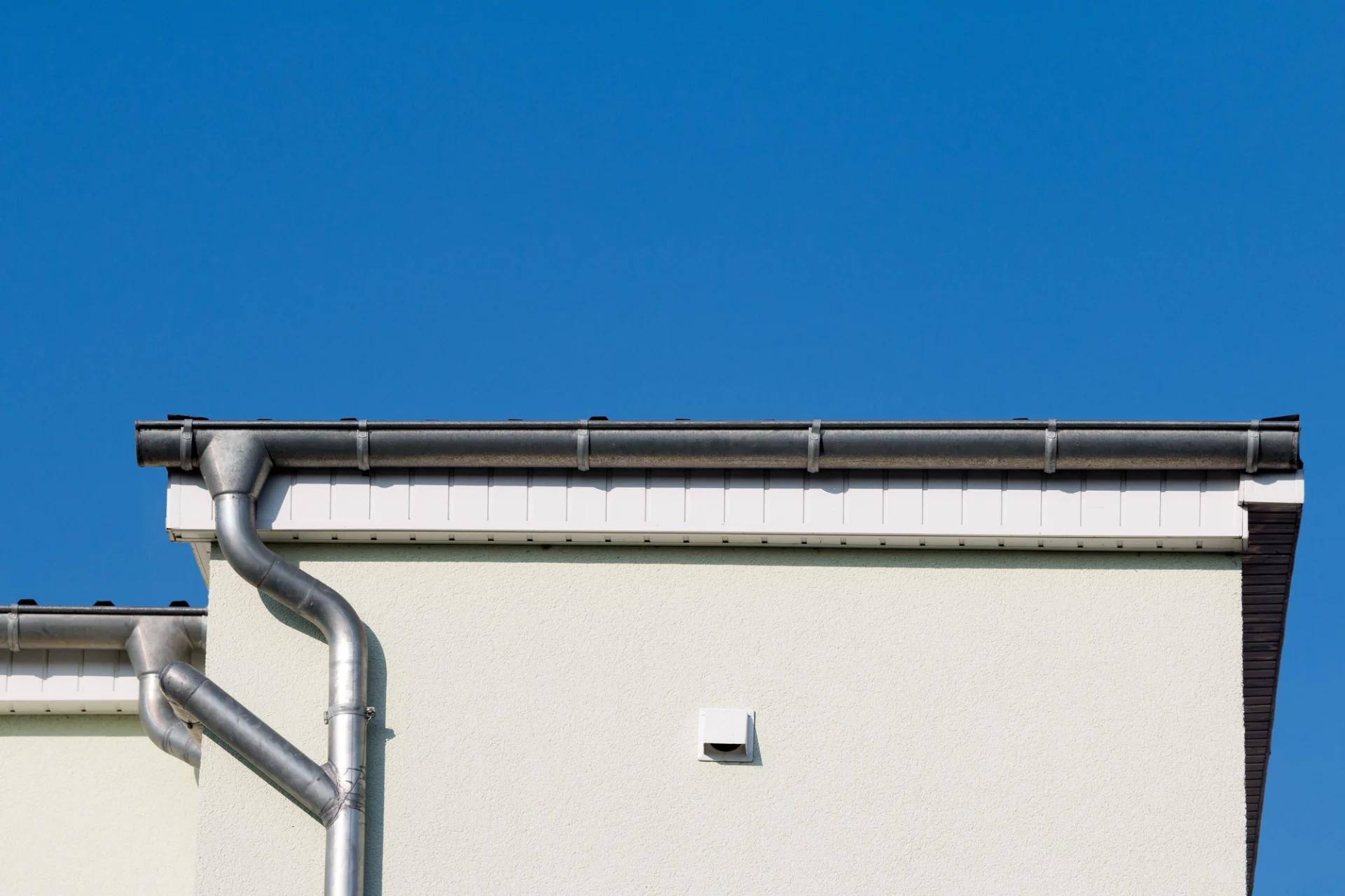 A heavy-duty gutter system on a commercial building