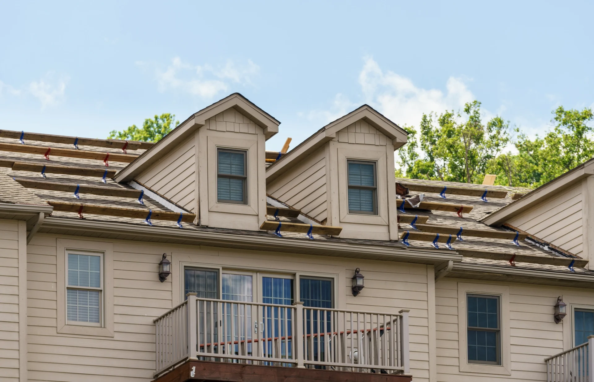 A duplex with boards on the roof for contractors to walk on while they work