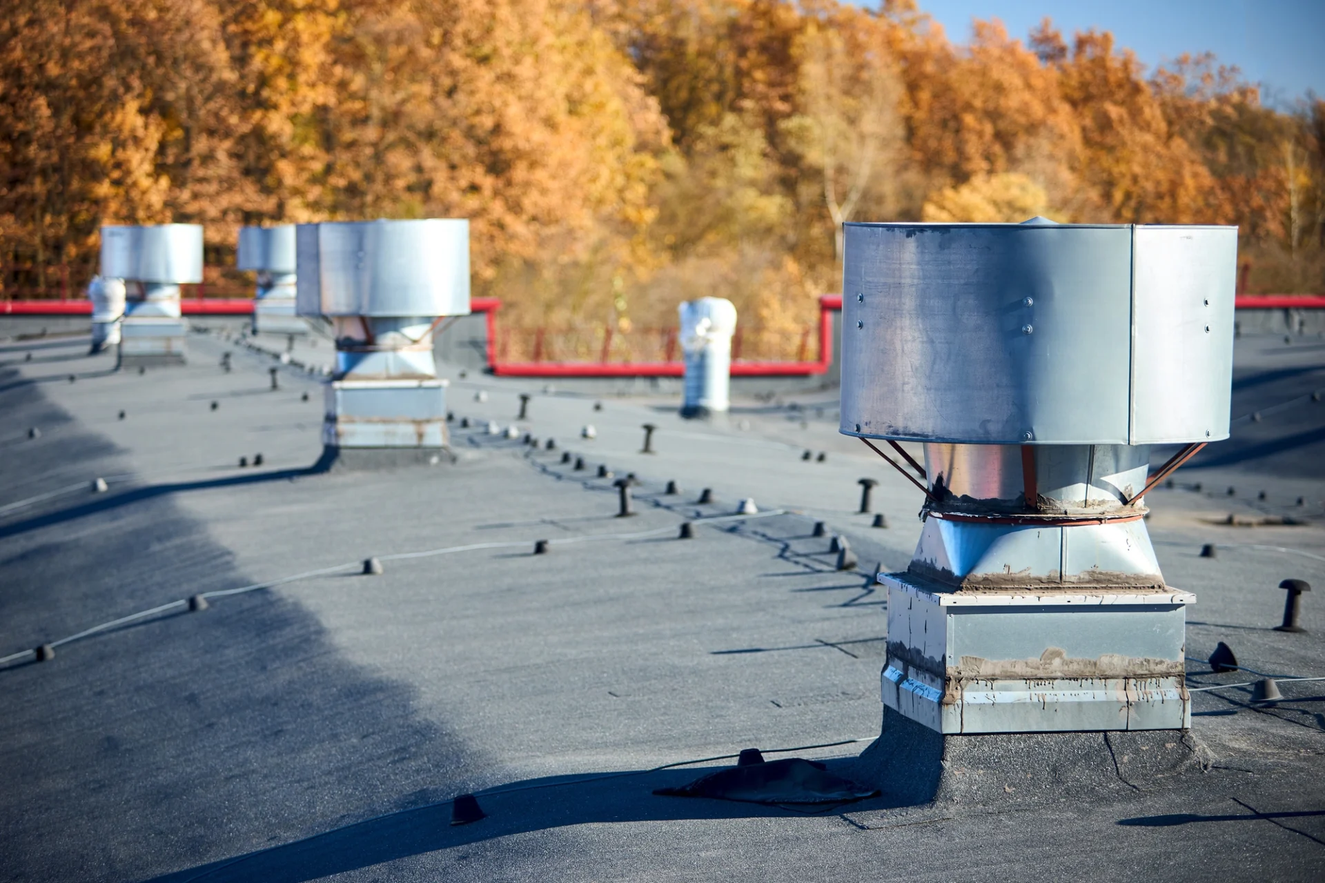 Close-up view of large industrial chimneys on a commercial building