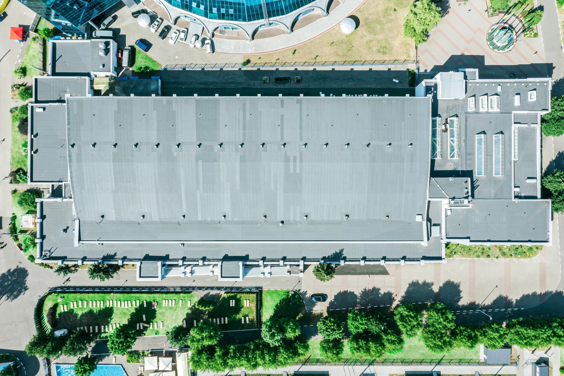 A top-down view of a large commercial building with a multi-tiered roof