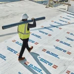 Aerial Shot Of Roofer On A Commercial Roof